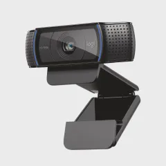 Logitech C920x HD Pro webcam and Logitech Litra Glow LED light on a home office desk with a laptop