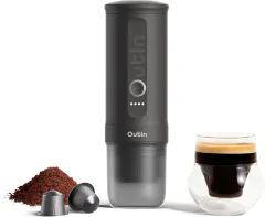 OutIn Nano portable electric espresso machine on a van kitchen counter with USB-C charging cable connected